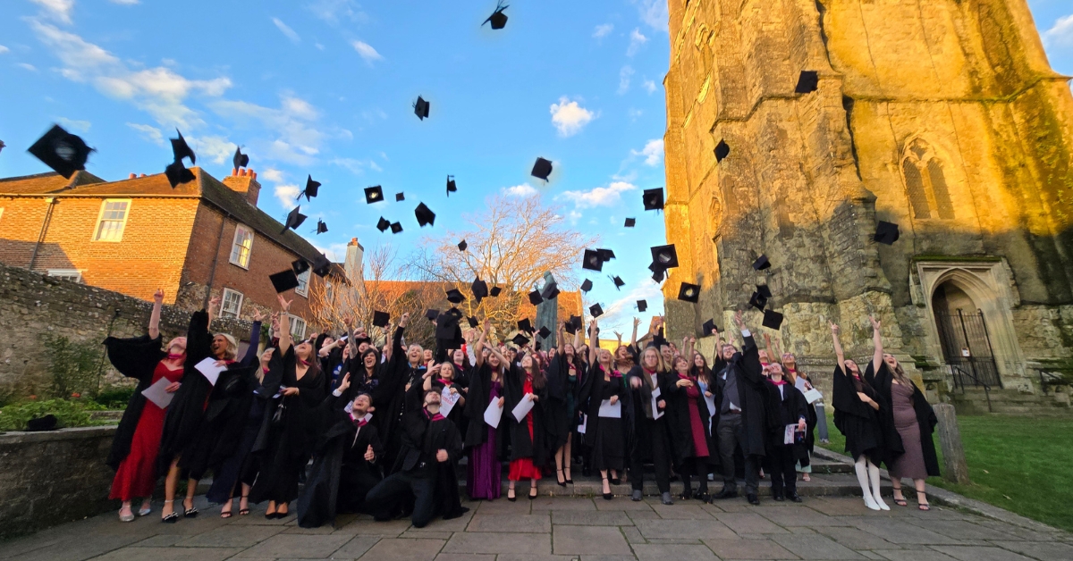 Our Graduates throwing their caps in the air outside the Cathedral